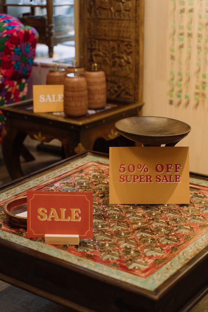 Elegant in-store display with 50% off super sale signs on a decorative table.